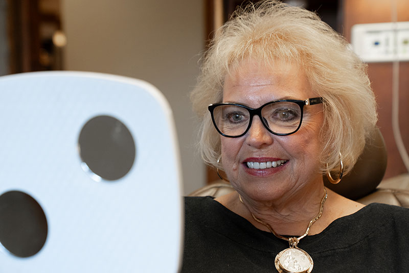 Paitent looking into mirror after cosmetic dental procedure