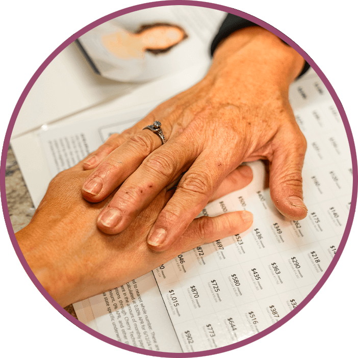 Team member and patient holding hands going over finance options