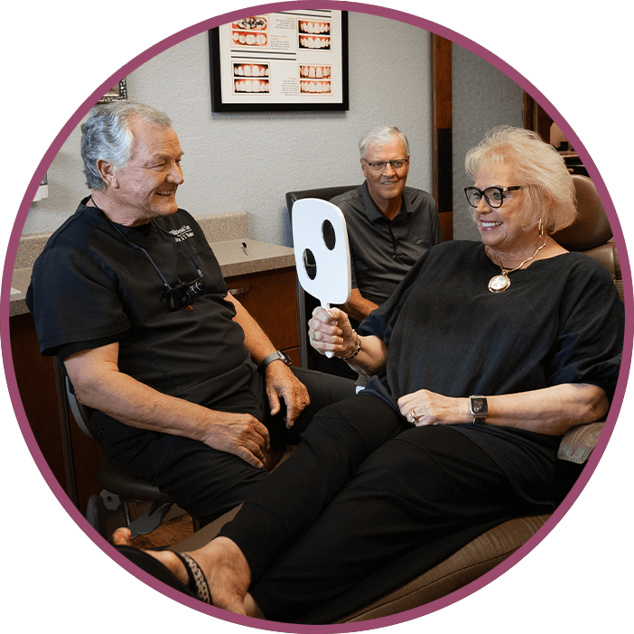 lady with black outfit and gold necklace dental implants