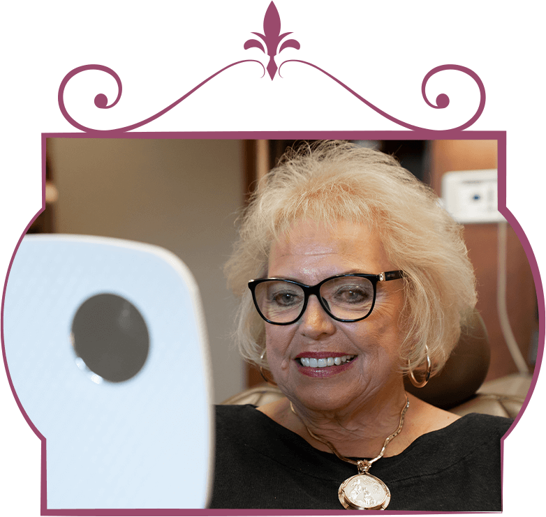 patient with her new full arch dental implants